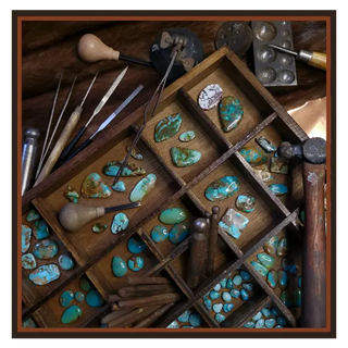 Jewelry-making tools and turquoise stones in a wooden box on a wooden surface | Texanna Belles Jewelry