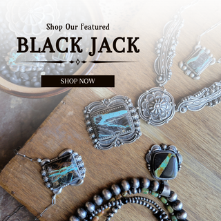 Silver jewelry with turquoise stones on a wooden surface, featuring 'Black Jack' brand.