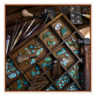 Wooden box with turquoise stones and jewelry-making tools on a wooden surface | Texanna Belles Jewelry