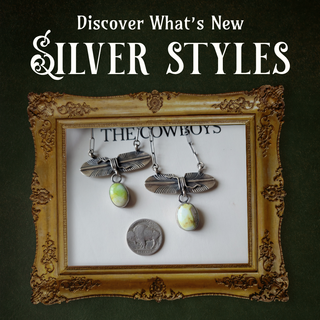 Silver dragonfly earrings with oval green and cream stones, displayed inside an ornate gold picture frame on a white card that reads 'THE COWBOYS'. The image has a dark green textured background with white text at the top reading 'Discover What's New SILVER STYLES'.